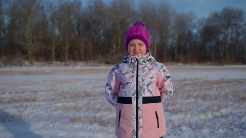360 roll child portrait looking at camera in winter outdoors Stock Footage 166585938