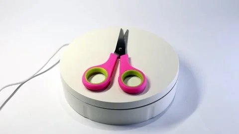 360° Rotation Video of Small Pink Paper Cutting Scissors on White Background Stock Footage 300550439