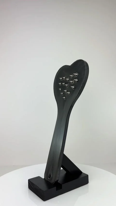 360 Sleek and Bold: Studded Paddle on a Rotating Stand 库存影片 270212547