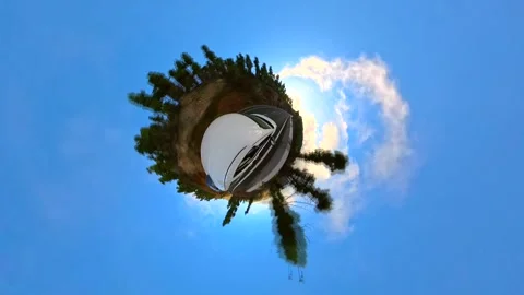 360 spherical video with "Tiny Planet" effect of white car driving Stock Footage 297887017