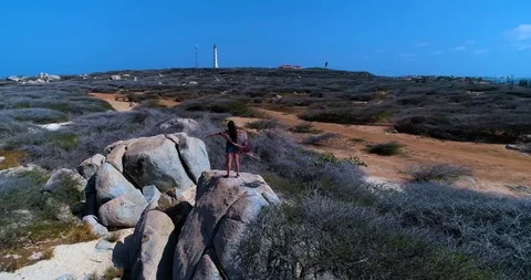 360 spin around model that raises her hands while standing on the rocks Stock-Footage 104578346