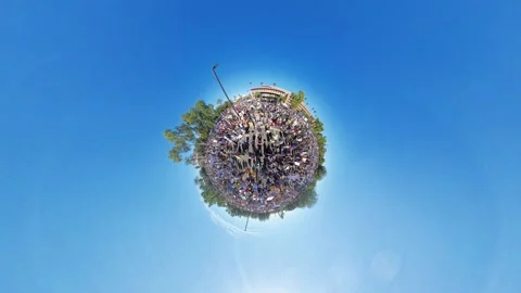 360 Tiny Planet Shot of Demonstration Crowd Under Clear Blue Sky 動画素材 327423254