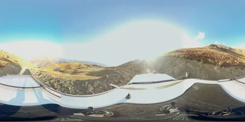 360 VR The SUV drives through mountainous terrain in clear weather Stock Footage 167424814