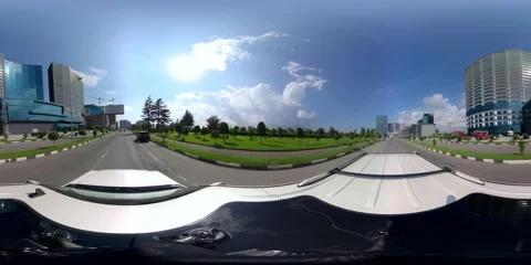 360 VR An SUV drives through the city along high-rise buildings Stock Footage 167650187