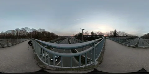360 VR Timelapse of man on highway bridge taking pictures of urban city skyline Stock Footage 101661563