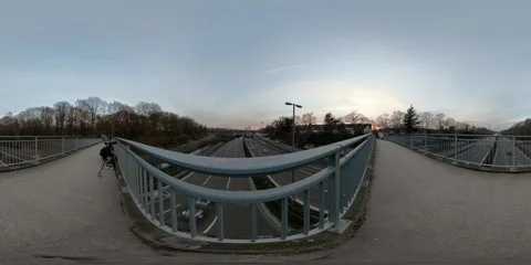 360 VR Timelapse of man on highway bridge taking pictures of urban city skyline Stock Footage 102763962
