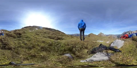 360 VR, two two young men resting on a cold, windy mountain in switzerland. Stock Footage 147375751
