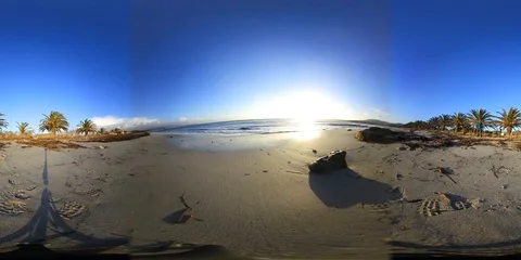 360 vr video of a sandy beach with rocks at sunset Stock Footage 99122589