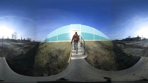 360 VR View at Man Entering Highway Via Noise Barrier Stock Footage 121270435