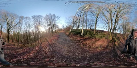 360 VR young man in winter clothing walking in forest onto lake viewpoint Stock Footage 101665960