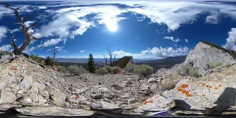 360VR Pale Grey Mountain Cliffs Under a Bright Sunny Blue Sky Stock Footage