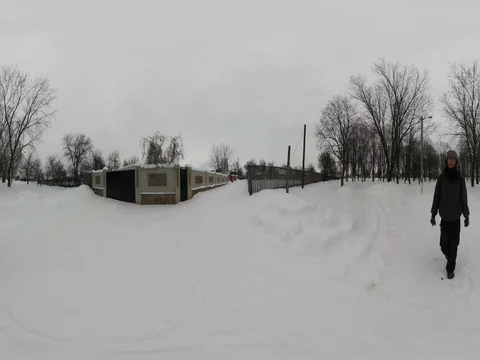 360Vr Video Man Between Fences of Houses Winter Snowy Cloudy Day Branch Trees Stock Footage