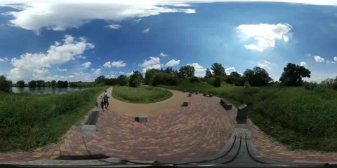 360Vr Video Man Gets on a Bicycle in Sunny Day Cyclist on Road Made of Paving Stock Footage 64723319