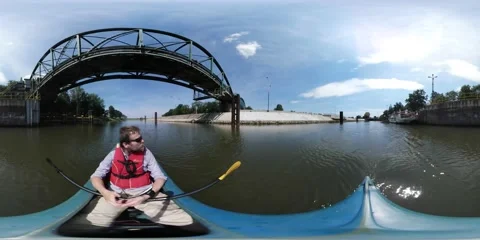 360Vr Video Man Kayaking Passing by Under Bridge by River Sunny Summer Day Man Stock Footage