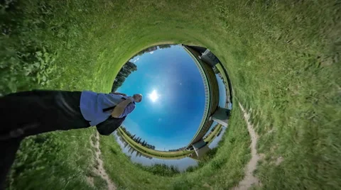 360Vr Video Man Walking by Grass Shows His Biceps Green Lawn Bridge Through Stock Footage 64312492