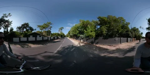 360VR Video of young man and woman riding on bikes Stock Footage 97909612