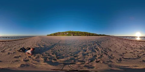 360VR Young man at the beach watching the sunset Stock Footage 97900183