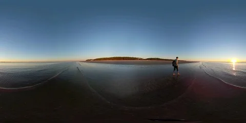 360VR Young man at the beach watching the sunset Stock Footage 97907624