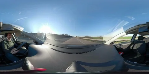 360VR young man driving in a car Stock Footage
