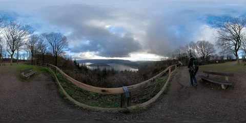 360VR Young man watching over lake landscape on viewpoint in the forest Stock Footage 101221488