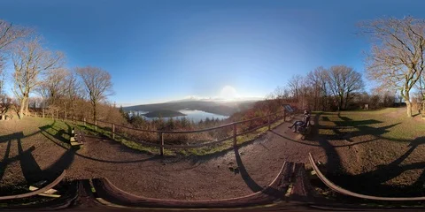 360VR Young man watching over lake landscape on viewpoint in the forest Stock Footage 101230213
