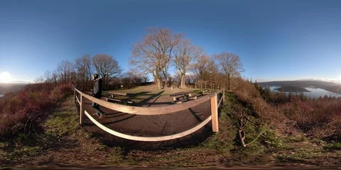 360VR Young man watching over lake landscape on viewpoint in the forest Stock Footage 101230716