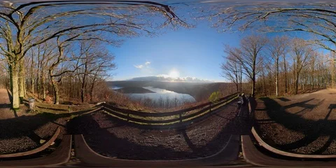 360VR Young man watching over lake landscape on viewpoint in the forest Stock Footage 101240463
