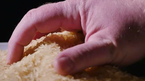 3711 Rice Being Picked Up with Hand in Slow Motion Stock Footage 51055192