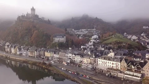 3a | FOG SETTING IN WHILE PANNING ACROSS A TOWN NAMED COCHEM | AERIAL Stock Footage 98996140