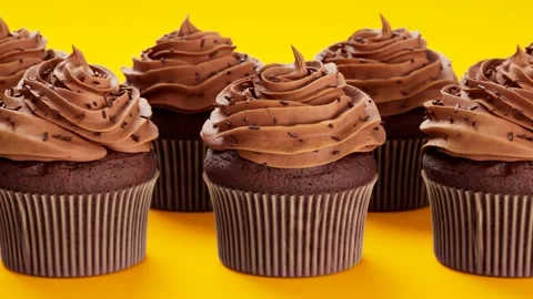 3D animation of assorted cupcakes with delicious chocolate cream. Sweet muffins. Video stock 133461373