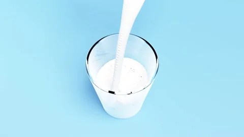 3d animation, Pour the milk or yogurt into a clear glass isolated on blue bac Stock Footage 212380784