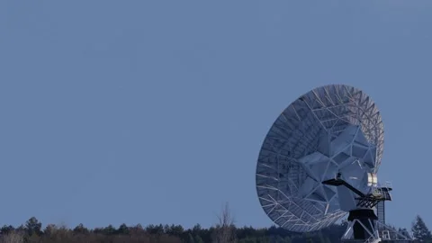 3D animation showing a large antenna dish moving to track a satellite Stock Footage 256654747