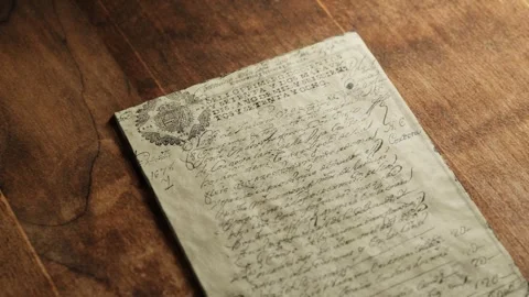 3D animation showing an old crumpled document lying on a wooden desk Stock Footage 306281072