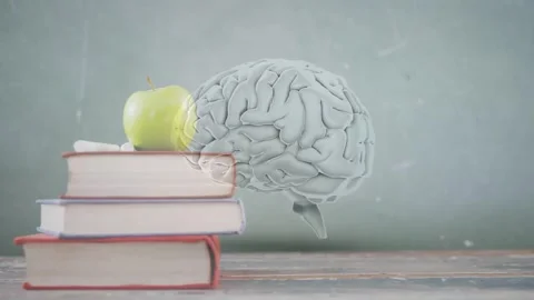 3D brain floating above desk as apple-topped books entering left causing yellow Stock Footage 334760309
