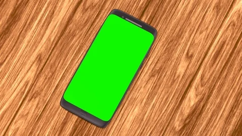3D CGI Render of smartphone on top of wooden table background with green screen Stock Footage 125999056