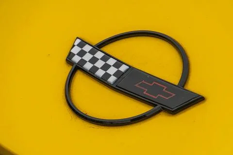 A 3D checkered flag model with a car emblem is depicted on a yellow backgro.. Stock Photos