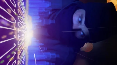 3D city model over binary coding against male hacker using laptop Stock Footage 312364445