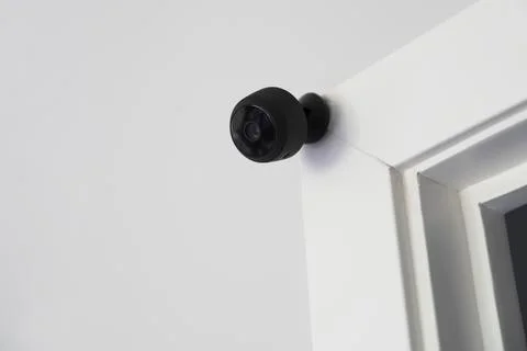 3D  closeup of a black security device above a door frame - home automation Ilustração Stock