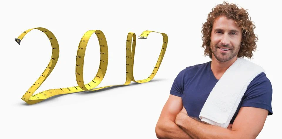 3D Composite image of smiling handsome trainer with arms crossed in gym Stock Photos