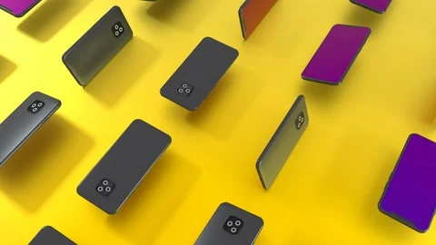 3D computer render of many smartphones rotating on yellow background surface. 4k Stock Footage 117831100