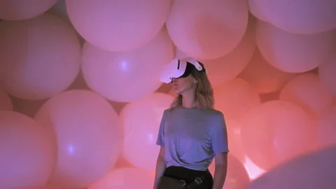 3d computer world surrounds woman playing virtual reality game with VR headset Stock Footage 220845166