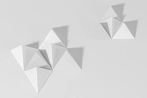 3D gray pyramid paper craft on a gray background Stock Photos