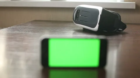 3D headset and a mobile phone on the table Stock Footage 65290064