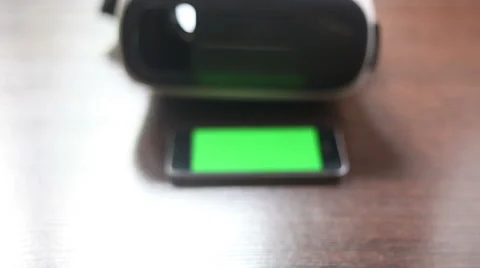 3D headset and a mobile phone on the table. Green background Stock Footage 65290087