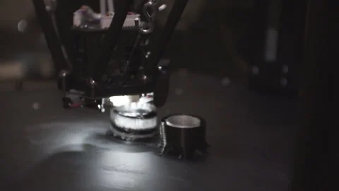 3D high-tech printer in action. 3D printer makes small figures. Artificial light Stock Footage 120610639