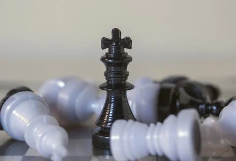 3d icon object of a black standing king chess piece surrounded by fallen pawn Stock Photos
