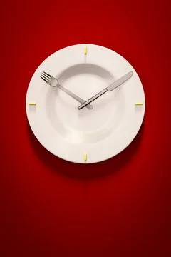 3d illustration of a dish clock on red background Stock Photos