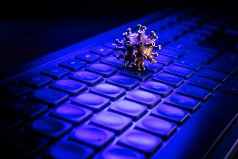 3D illustration of a virus model resting on a computer keyboard, illuminate.. Stock Photos