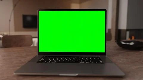 3D Laptop with green screen on display in home office Stock Photos
