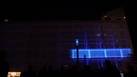 3D light show on flat exterior wall of large building at Glow event in Vídeos de archivo 120559985